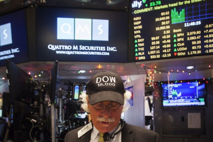 Trader Peter Tuchman wears a &quot;Dow 18,000&quot; cap as he works on the floor of the New York Stock Exchange in New York, December 23, 2014. U.S. stocks advanced on Tuesday, as the Dow climbed above the 18,000 mark for the first time in history and the