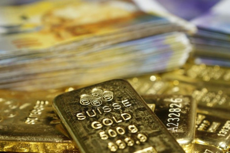 Gold bars and Swiss Franc banknotes are seen in this illustration picture taken at the GSA in Vienna November 13, 2014. Swiss voters looked set November 30, 2014, to clearly reject proposals that would have forced the central bank to buy up massive amount