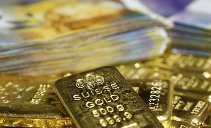 Gold bars and Swiss Franc banknotes are seen in this illustration picture taken at the GSA in Vienna November 13, 2014. Swiss voters looked set November 30, 2014, to clearly reject proposals that would have forced the central bank to buy up massive amount