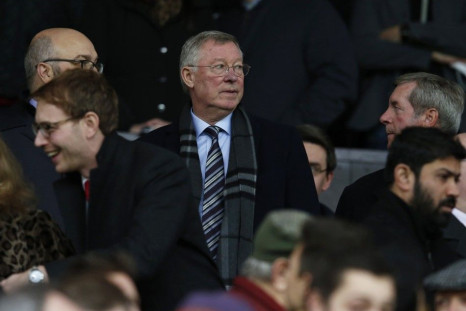 Former Manchester United manager Alex Ferguson (C) takes his seat before their English Premier League soccer match against Liverpool at Old Trafford in Manchester, northern England December 14, 2014.