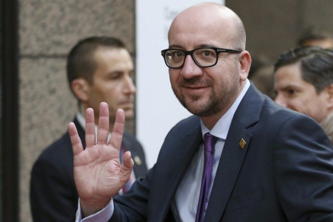 Belgium's Prime Minister Charles Michel waves as he arrives at an European Union leaders summit in Brussels October 24, 2014.