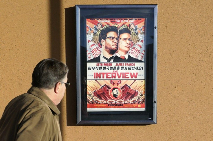 A man walks by the poster for the film &quot;The Interview&quot; outside the Alamo Drafthouse theater in Littleton, Colorado December 23, 2014. Sony Pictures said on Tuesday it will release &quot;The Interview&quot; to a limited number of theatres on Dece