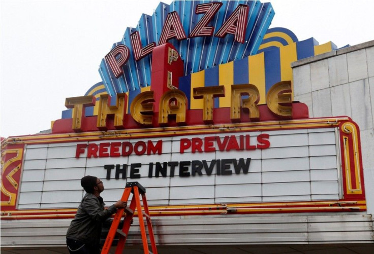 General Manager Brandon Delaney looks up at the marquee sign after the announcement that the Plaza Theatre would be showing the movie &quot;The Interview&quot; beginning Christmas Day in Atlanta