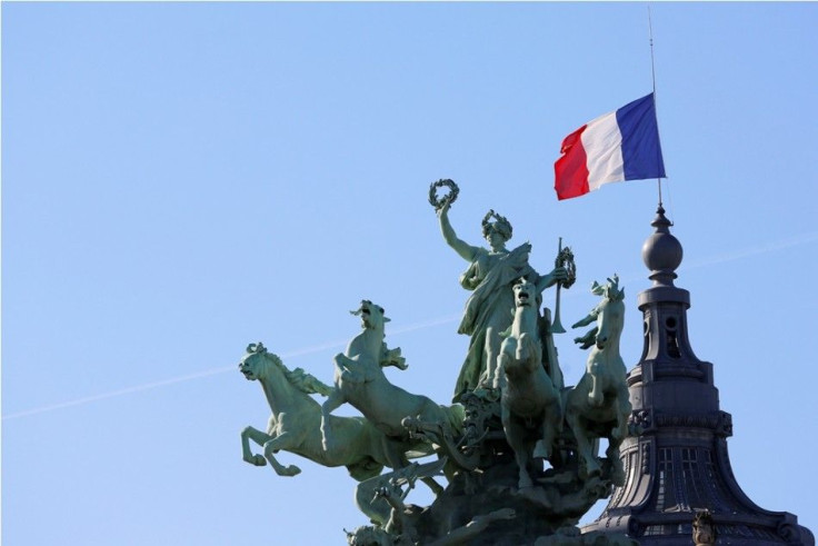 The French flag flies at half-mast above the Grand Palais in Paris September 26, 2014 to pay tribute to French mountain guide Herve Gourdel