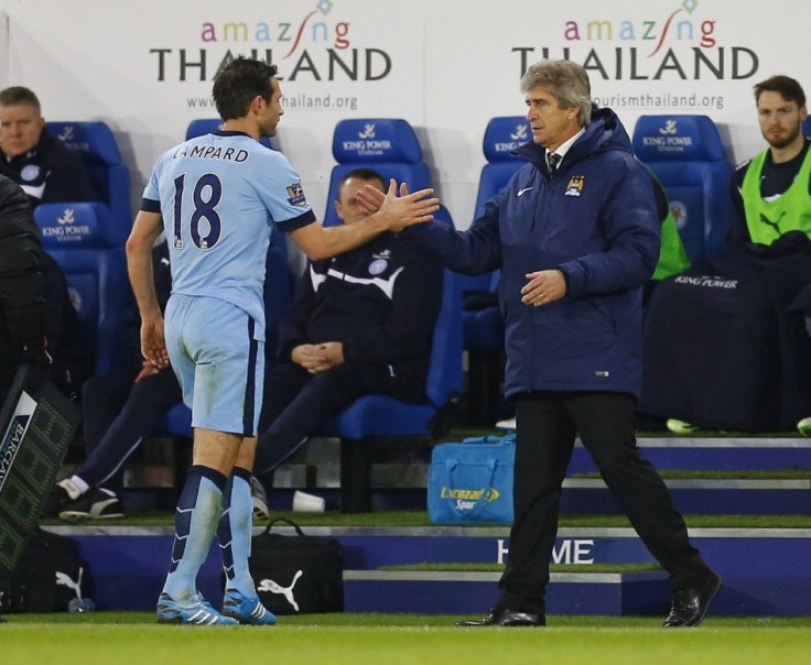 Manchester City's Frank Lampard (L) slaps hands with manager Manuel Pellegrini after being substituted during their English Premier League soccer match against Leicester City at the King Power Stadium in Leicester, central England December 13, 2014.