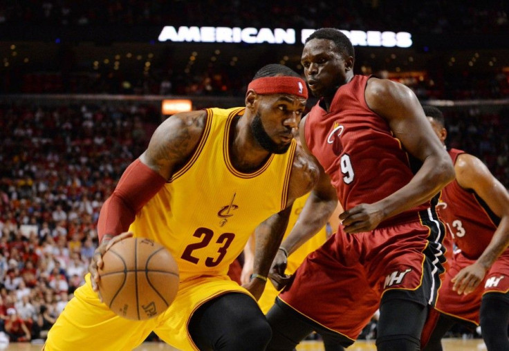 Dec 25, 2014; Miami, FL, USA; Cleveland Cavaliers forward LeBron James (23) drives to the basket around Miami Heat forward Luol Deng (9) during the first half at American Airlines Arena.