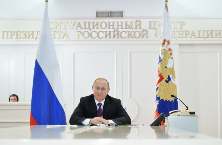 Russian President Vladimir Putin takes part in a video conference with members of the Russian Geographical Society expedition to the Southern Pole in Moscow, December 26, 2014. Putin has signed a new military doctrine, naming NATO expansion among key exte