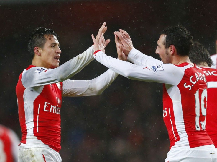 Arsenal's Alexis Sanchez (L) celebrates with team-mate Santi Cazorla after scoring a goal against Queens Park Rangers' during their English Premier League soccer match at the Emirates Stadium in London December 26, 2014.