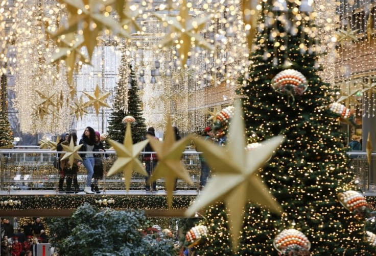 People walk in a shopping mall decorated with Christmas lights in Berlin, December 19, 2014. REUTERS/Fabrizio Bensch