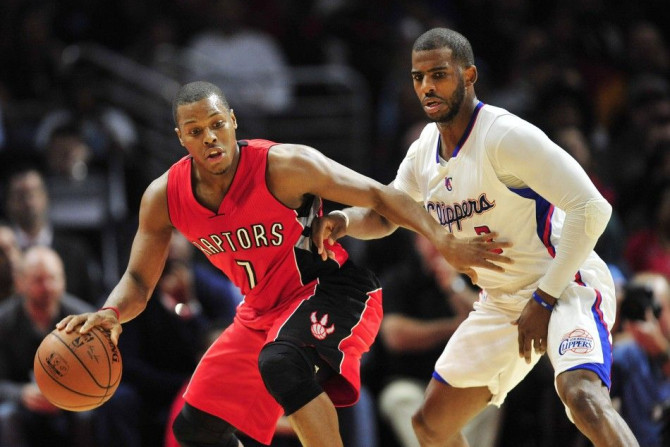 December 27, 2014; Los Angeles, CA, USA; Toronto Raptors guard Kyle Lowry (7) controls the ball against the defense of Los Angeles Clippers guard Chris Paul (3) during the second half at Staples Center.