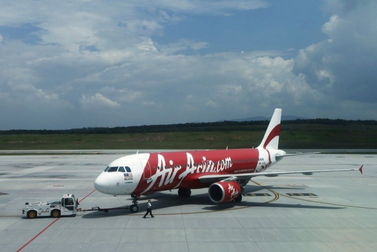 Air Asia aircraft model 9M-AQB is seen on track at Low Cost Carrier Terminal (LCCT) airport at Sepang outside Kuala Lumpur November 19, 2013. Malaysia's AirAsia Bhd will take up to two years to realise a profit from its Indonesia and Philippine units, inc