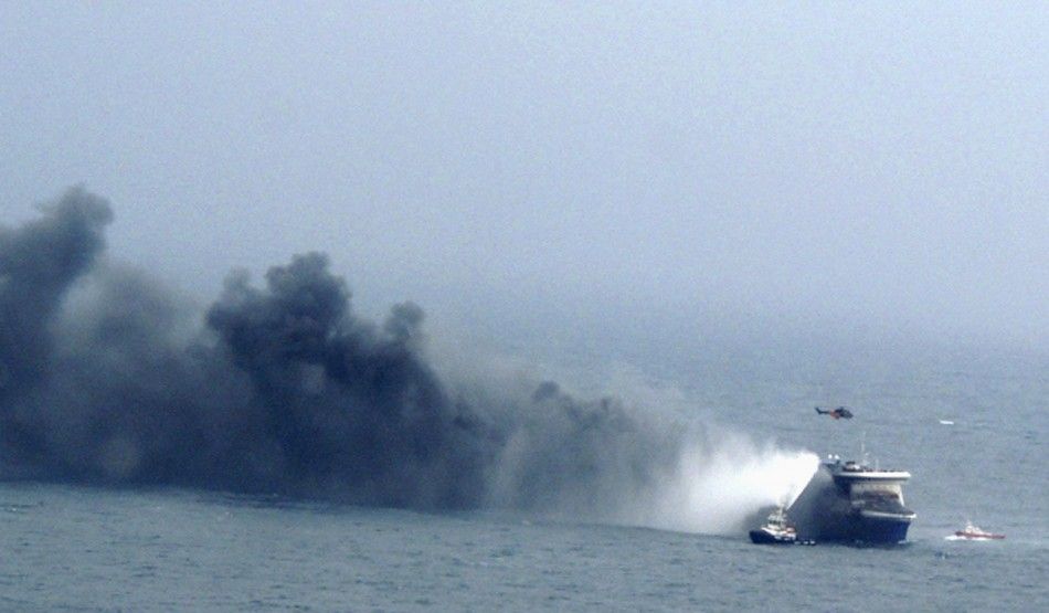 The car ferry Norman Atlantic burns in waters off Greece December 28, 2014 in this handout photo provided by Marina Militare. Italian and Greek helicopter crews prepared to work through the night to airlift passengers in pairs off a burning ferry adrift i