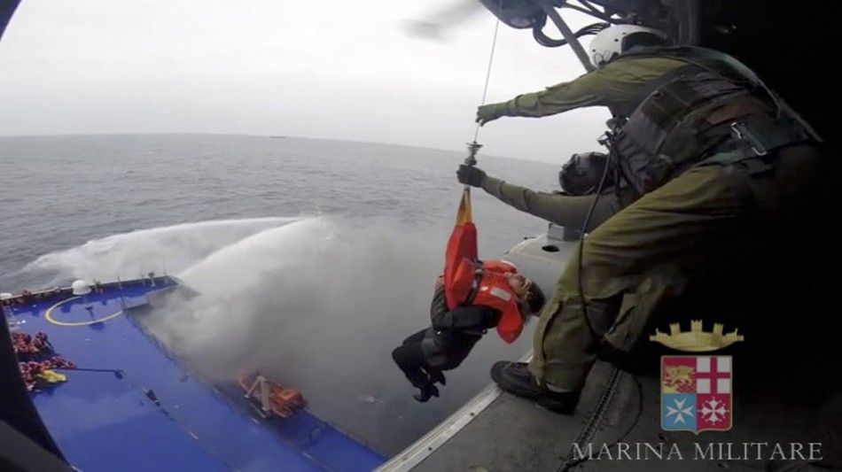 A person is lifted on an Italian Navy helicopter as the car ferry Norman Atlantic burns in waters off Greece December 28, 2014 in this handout video grab of the Italian Marina Militare. Italian and Greek helicopter crews prepared to work through the night