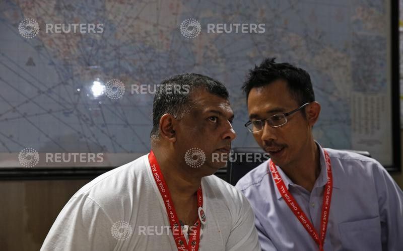 AirAsia CEO Tony Fernandes L talks with director Sunu Widyatmoko during a news conference 