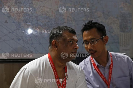 AirAsia CEO Tony Fernandes (L) talks with director Sunu Widyatmoko during a news conference 