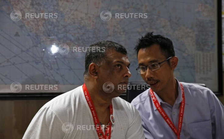 AirAsia CEO Tony Fernandes (L) talks with director Sunu Widyatmoko during a news conference 