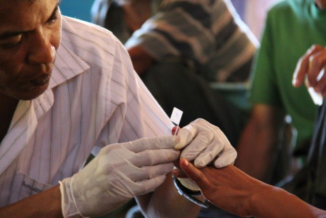 A government health worker takes a blood sample to be tested for malaria in Ta Gay Laung village hall in Hpa-An district in Kayin state, south-eastern Myanmar, November 28, 2014. Malaria death rates dropped by 47 percent between 2000 and 2014 worldwide bu