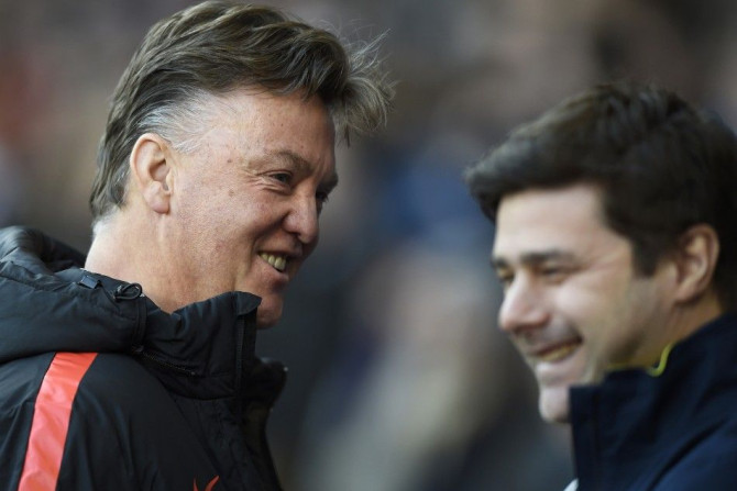 Tottenham Hotspur manager Mauricio Pochettino (R) speaks to Manchester United manager Louis van Gaal before their English Premier League soccer match at White Hart Lane in London December 28, 2014.