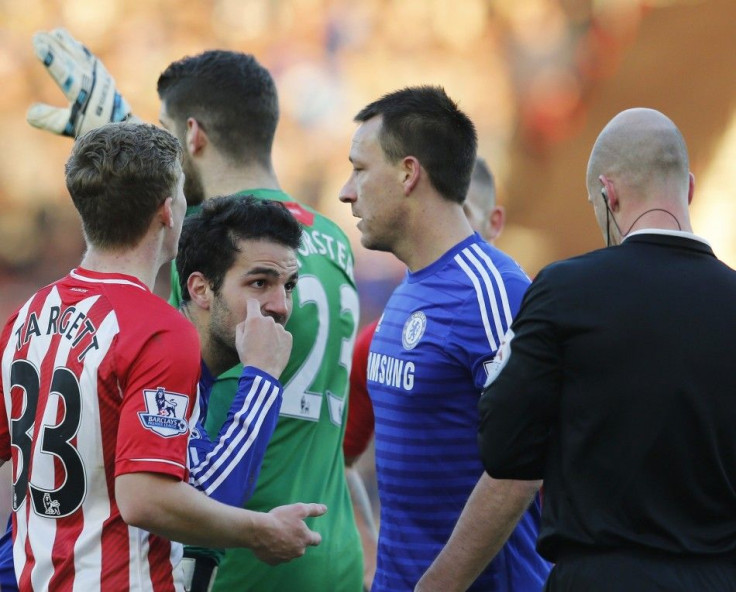 Cesc Fabregas of Chelsea reacts as he booked for diving in the area by referee Anthony Taylor during their English Premier League soccer match against Southampton at St Mary's Stadium in Southampton, southern England, December 28, 2014.