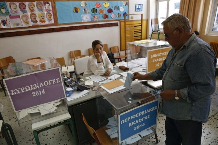 A man casts his ballot inside a classroom used as a polling station in Athens May 25, 2014. Greeks voted in European and local elections on Sunday under the shadow of increased poverty and unemployment following four years of belt tightening by the govern