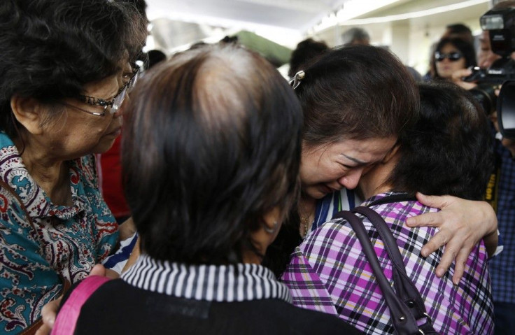 Relatives of passengers onboard AirAsia flight QZ8501 cry in a waiting area at Juanda International Airport in Surabaya December 29, 2014. A missing AirAsia jet carrying 162 people could be at the bottom of the sea after it was presumed to have crashed of