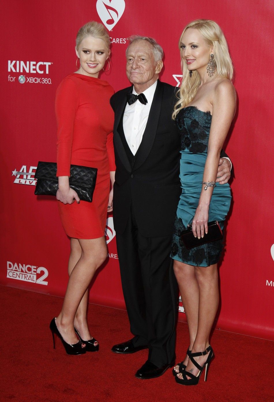 Anna Berglund L, Hugh Hefner C, and Shera Bechard pose at the 2012 MusiCares Person of the Year tribute honoring Paul McCartney in Los Angeles, February 10, 2012