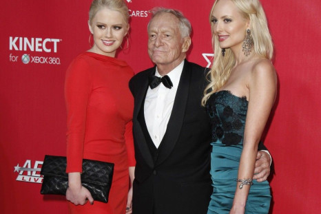 Anna Berglund (L), Hugh Hefner (C), and Shera Bechard pose at the 2012 MusiCares Person of the Year tribute honoring Paul McCartney in Los Angeles, February 10, 2012
