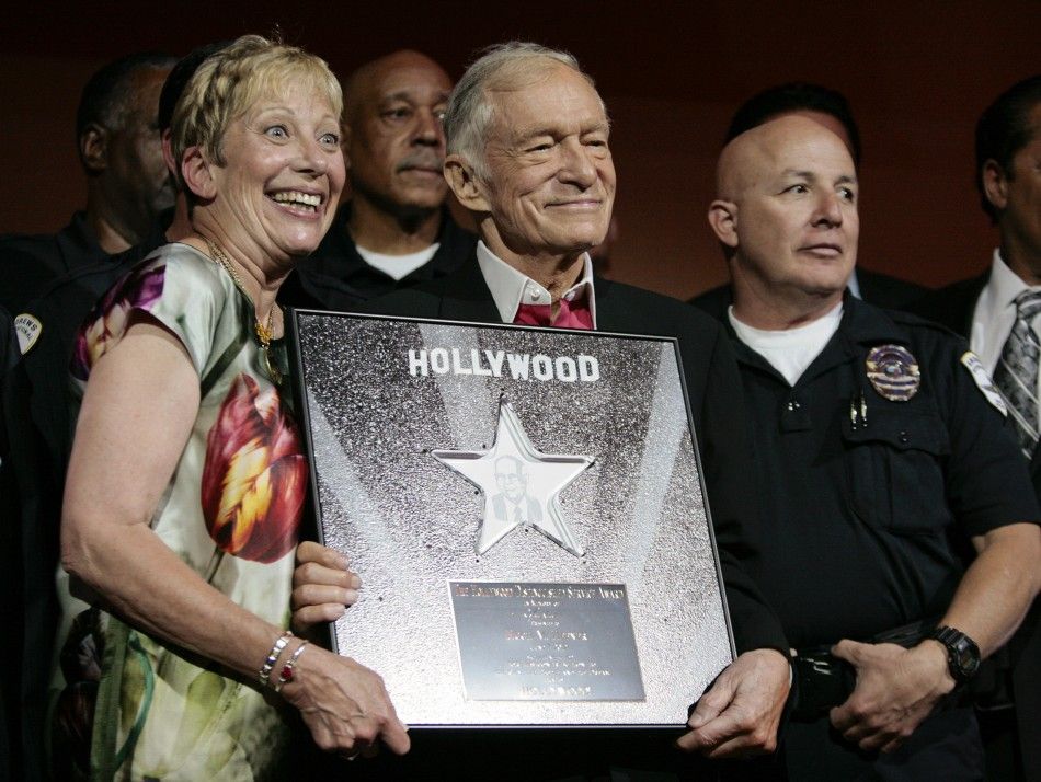 Hugh Hefner 2nd L, founder, editor-in-chief and creative officer of Playboy, poses with community advocate Laurie Goldman L and others as he is honored with the Hollywood Distinguished Service Award in Memory of Johnny Grant in Hollywood, California 