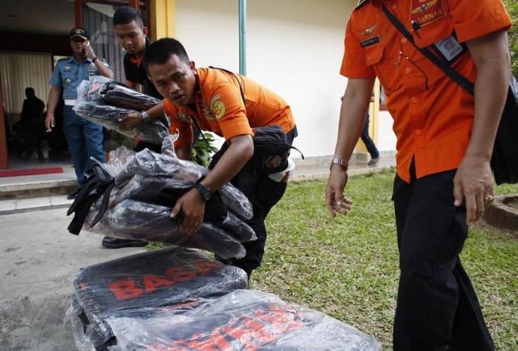 Search and rescue workers prepare to load body bags onto a flight to Kalimantan in Pangkal Pinang, Bangka December 30, 2014. Indonesian rescuers saw bodies and luggage off the coast of Borneo island on Tuesday and officials said they were &quot;95 percent