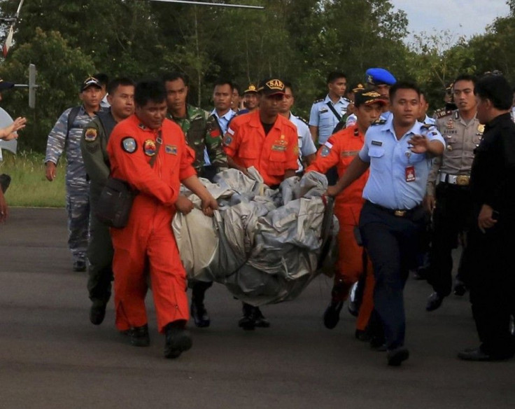 Members of the Search and Rescue Agency SARS carry debris recovered from the sea presumed from missing Indonesia AirAsia flight QZ 8501 at Pangkalan Bun, Central Kalimantan, December 30, 2014 in this photo taken by Antara Foto.