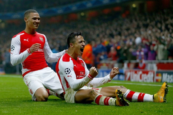 Arsenal's Alexis Sanchez celebrates with his team mate Kieran Gibbs (L) after scoring a goal against Borussia Dortmund during their Champions League group D soccer match in London November 26, 2014.