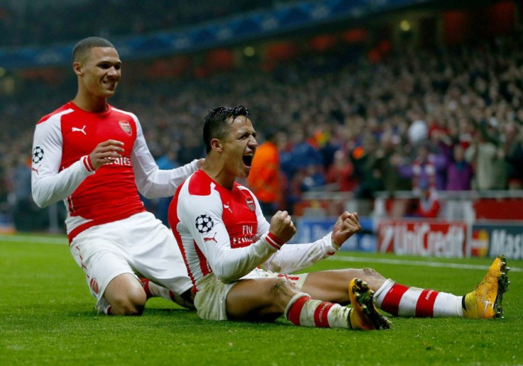 Arsenal's Alexis Sanchez celebrates with his team mate Kieran Gibbs (L) after scoring a goal against Borussia Dortmund during their Champions League group D soccer match in London November 26, 2014.