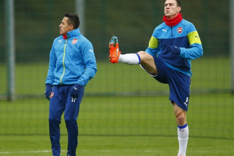 Arsenal's Alexis Sanchez (L) and Laurent Koscielny attend a training session ahead of their Champions League soccer match against Borussia Dortmund, at their training facility in London Colney, north of London, November 25, 2014.