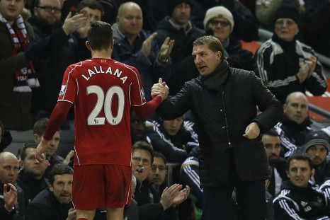 Liverpool's manager Brendan Rodgers (R) shakes hands with Adam Lallana during their English Premier League soccer match against Swansea City at Anfield in Liverpool, northern England December 29, 2014.