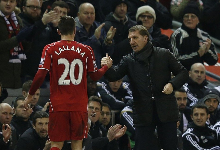 Liverpool's manager Brendan Rodgers (R) shakes hands with Adam Lallana during their English Premier League soccer match against Swansea City at Anfield in Liverpool, northern England December 29, 2014.