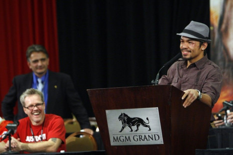 Manny Pacquiao of the Philippines speaks during a news conference following his WBO welterweight victory over Miguel Cotto of Puerto Rico at the MGM Grand Garden Arena in Las Vegas, Nevada on November 14, 2009. Listening at left are head trainer Freddie R
