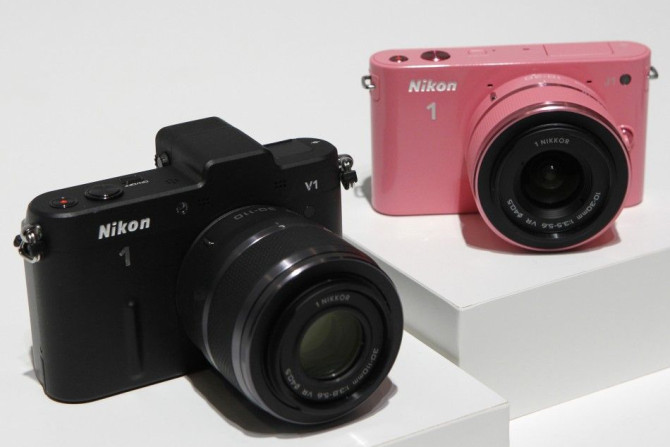 Nikon Corp&#039;s new camera Nikon 1 V1 (L) and J1 are displayed at its unveiling ceremony in Tokyo September 21, 2011. Nikon unveiled its first mirrorless cameras on Wednesday, beating its arch rival Canon to the nascent market for small, interchangeable