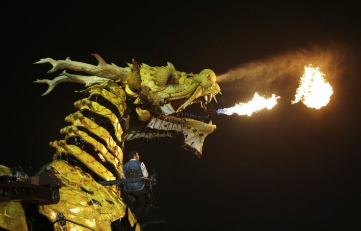 A mechanical installation named &quot;Long Ma&quot; breathes fire during the Long Ma performance in front of the National Stadium, also known as the Bird&#039;s Nest, on a hazy night in Beijing, October 19, 2014. &quot;Long Ma&quot;, a 17-meter (56-ft) lo