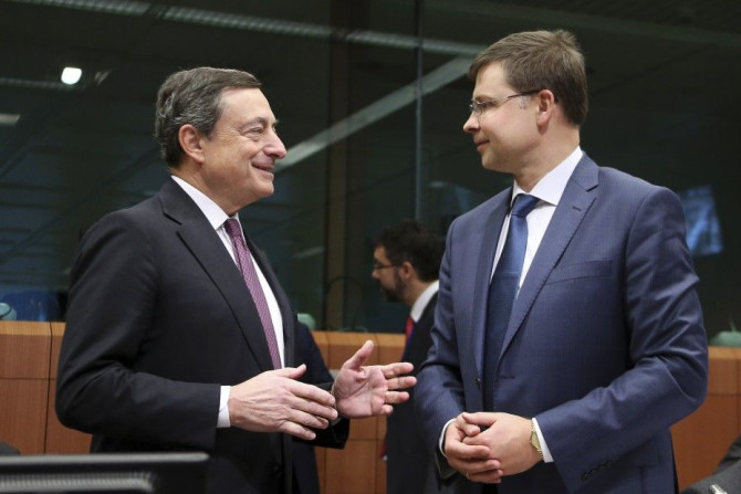 European Central Bank (ECB) President Mario Draghi and European Euro and Social Dialogue Commissioner Valdis Dombrovskis (R)