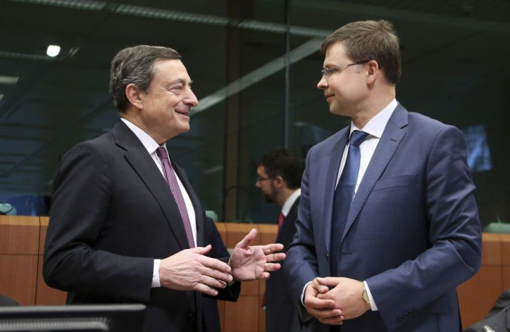 European Central Bank (ECB) President Mario Draghi and European Euro and Social Dialogue Commissioner Valdis Dombrovskis (R)