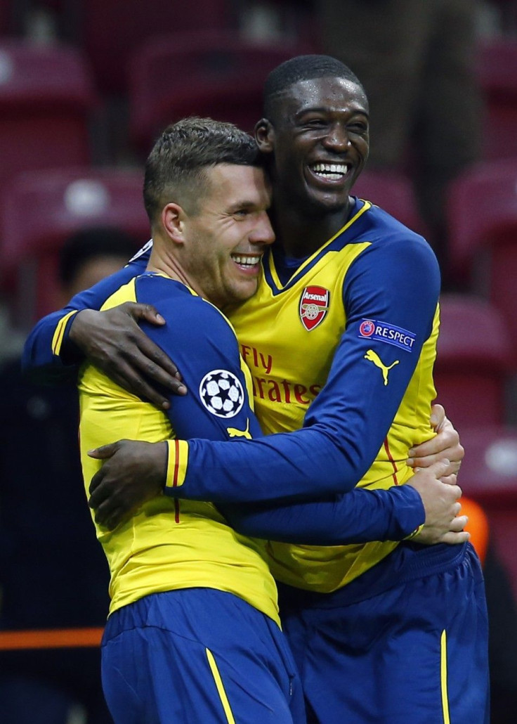 Arsenal's Lukas Podolski celebrates his second goal against Galatasaray with team mate Yaya Sanogo (R) during their Champions League Group D soccer match at Ali Sami Yen Spor Kompleksi in Istanbul December 9, 2014.