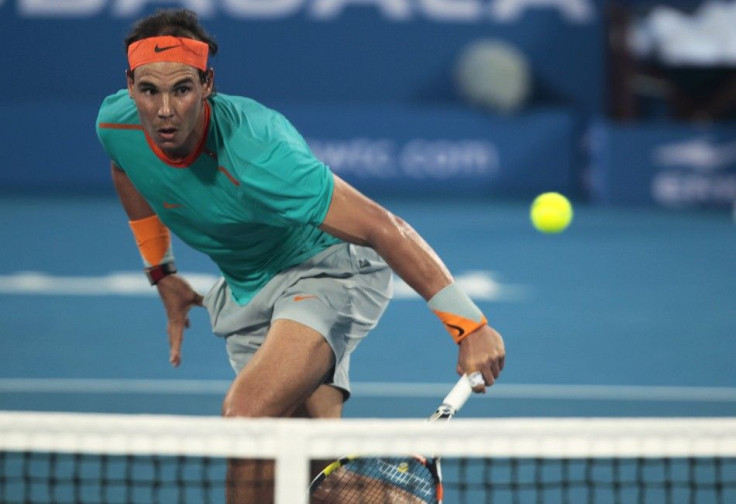 Rafael Nadal of Spain returns the ball to Andy Murray of Britain during their semi-final match at the Mubadala World Tennis Championship in Abu Dhabi January 2, 2015. REUTERS/Martin Dokoupil