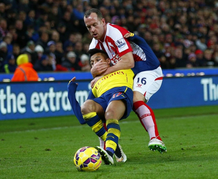 Stoke City&#039;s Charlie Adam (top) gets a yellow card for this foul on Arsenal&#039;s Alexis Sanchez during their English Premier League soccer match in Stoke, northern England December 6, 2014.