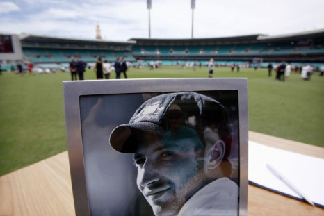 A photograph of Australian cricketer Phillip Hughes is displayed next to a condolences book at the Sydney Cricket Ground (SCG) December 3, 2014. The funeral of Australian test cricketer Phillip Hughes began to the strains of a song entitled &quot;Forever 