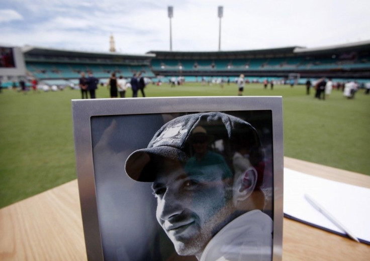 A photograph of Australian cricketer Phillip Hughes is displayed next to a condolences book at the Sydney Cricket Ground (SCG) December 3, 2014. The funeral of Australian test cricketer Phillip Hughes began to the strains of a song entitled &quot;Forever 