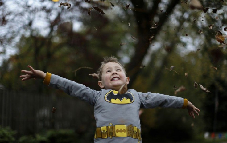 Benjamin Rocamp, who dressed as Batman, celebrates Halloween at the Flint family's annual Halloween block party