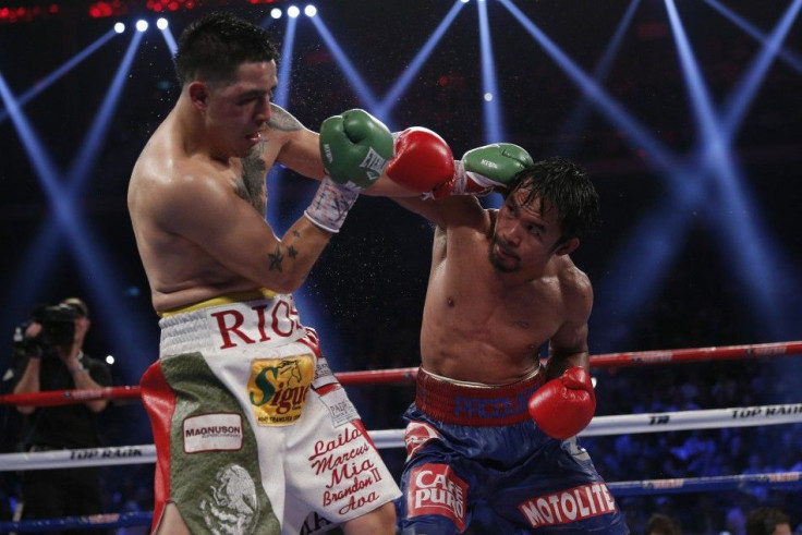 Manny Pacquiao of the Philippines fights Brandon Rios (L) of the U.S. during their World Boxing Organisation (WBO) International 12-round welterweight boxing title fight at the Venetian Macao hotel in Macau November 24, 2013. Pacquiao scored a decisive, u