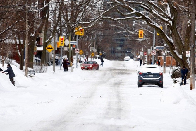 Residents dig out of the snow following an overnight snow storm in Toronto