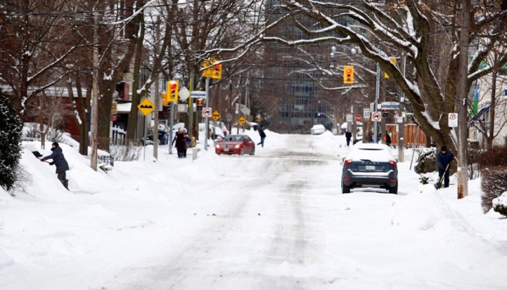 Residents dig out of the snow following an overnight snow storm in Toronto