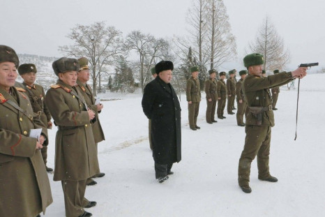 North Korean leader Kim Jong Un (C) stands in the snow as he inspects KPA Unit 1313 